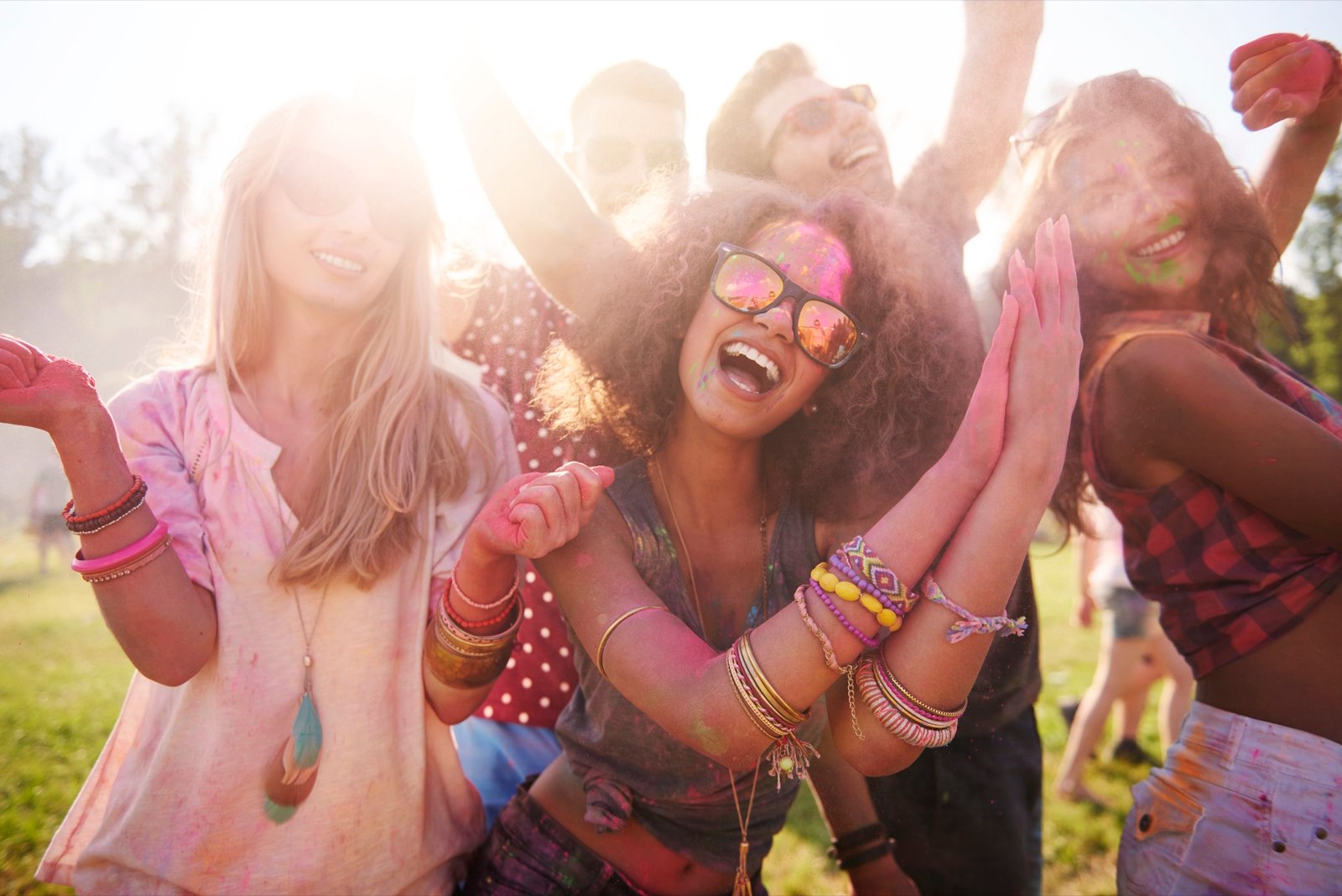 Friends celebrating outdoors with colorful powder